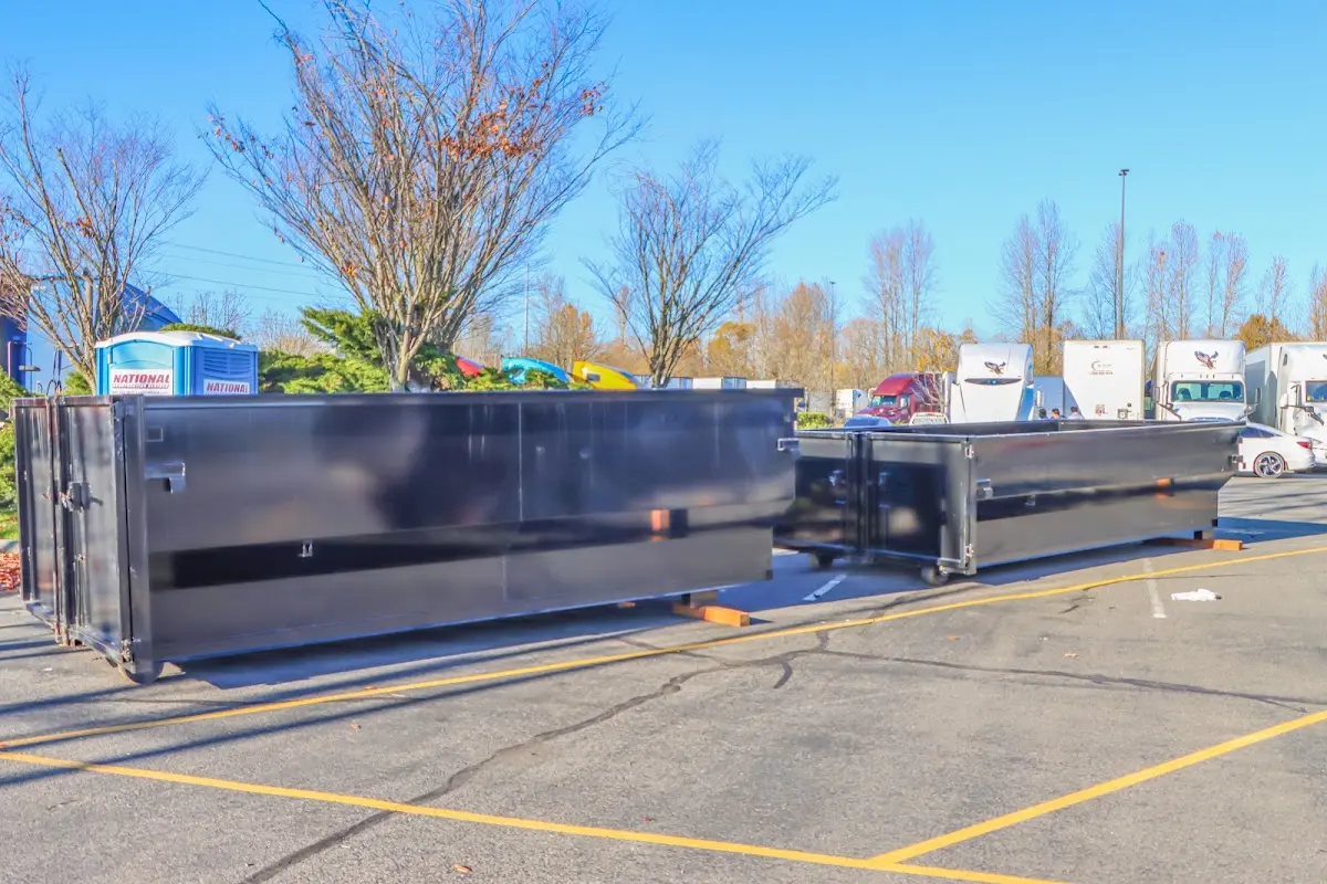 Professional dumpster rental service with roll-off container on residential driveway in Leonardtown